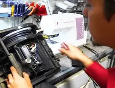 Vacuum repair technician servicing internal components on a workbench in Tempe, AZ