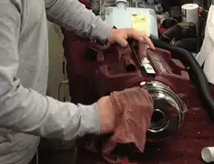 Vacuum repair technician cleaning and servicing a vacuum motor in Tempe, AZ