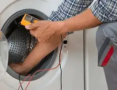 Washing machine repair technician testing a front-load washer with diagnostic tools in Tempe, AZ
